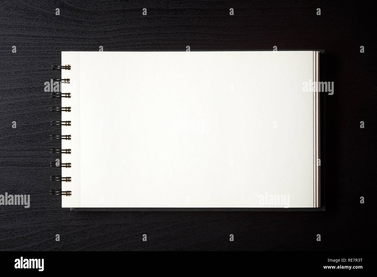 White empty notebook on black table, top view Stock Photo