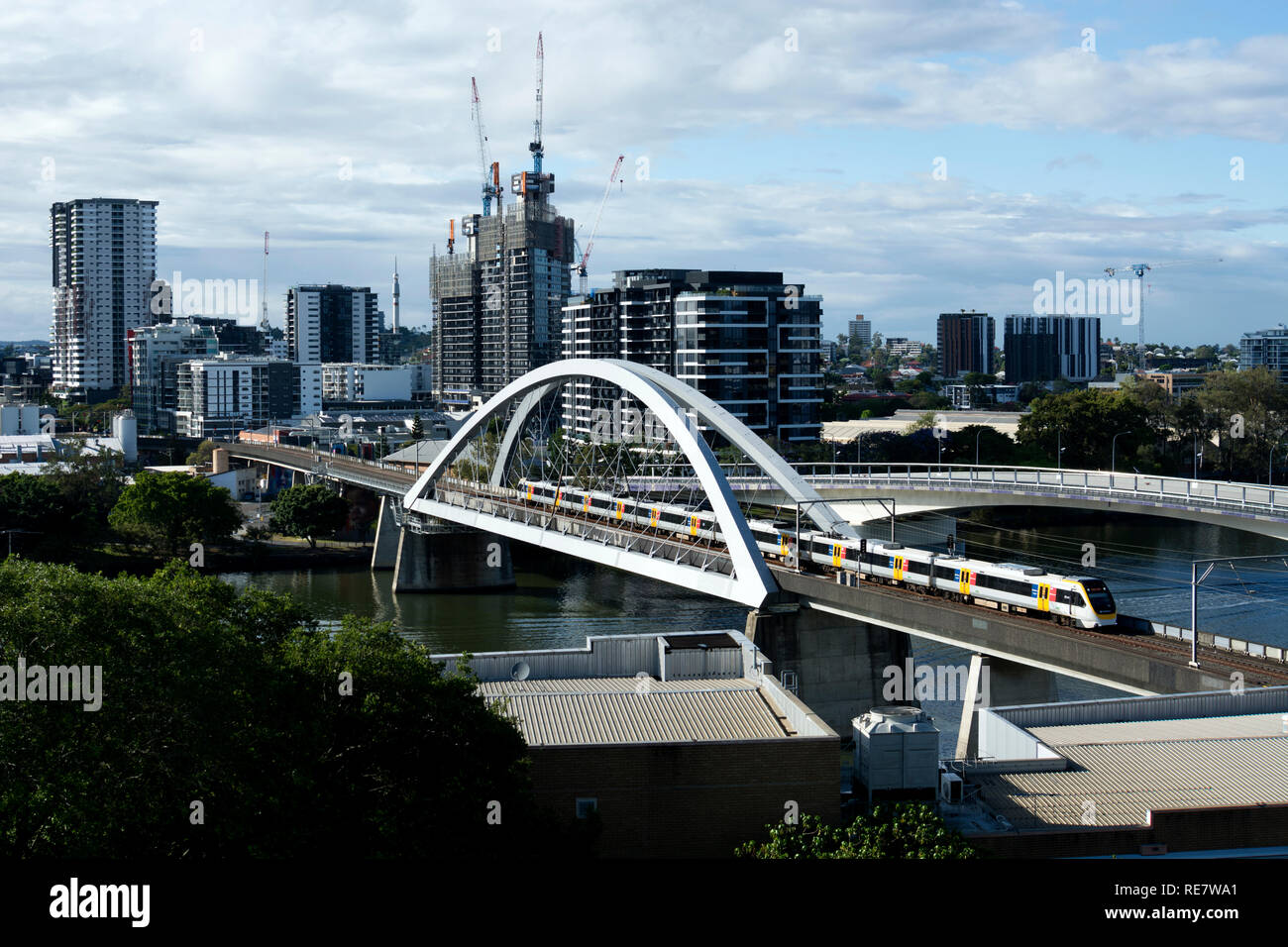 A Queensland Rail train crossing Merivale Bridge, early morning, Brisbane, Queensland, Australia Stock Photo