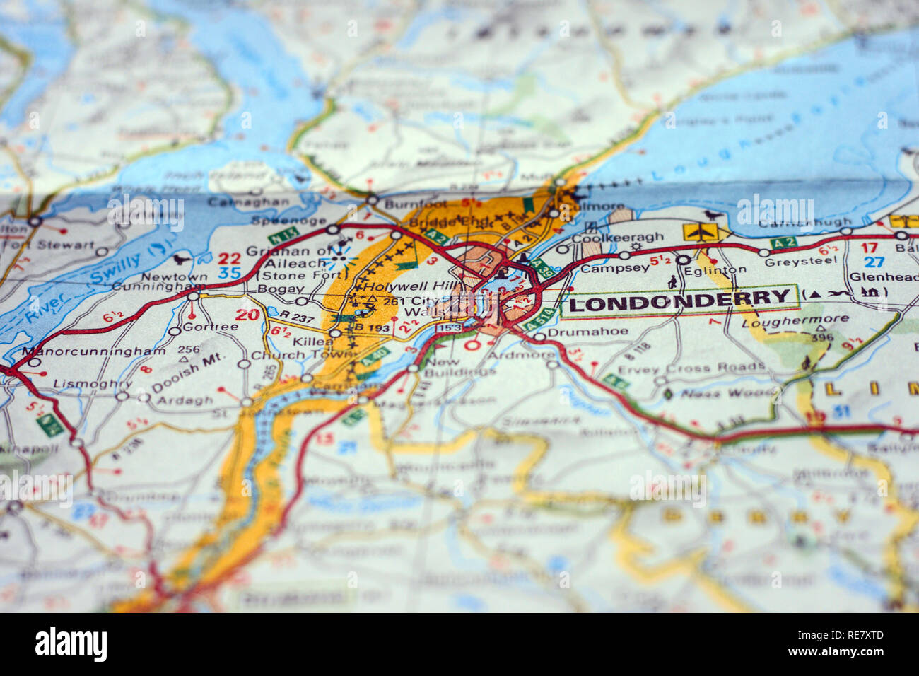 Selectively focused city of Londonderry on a paper map with border between Norhern Ireland and Irish Republic Stock Photo