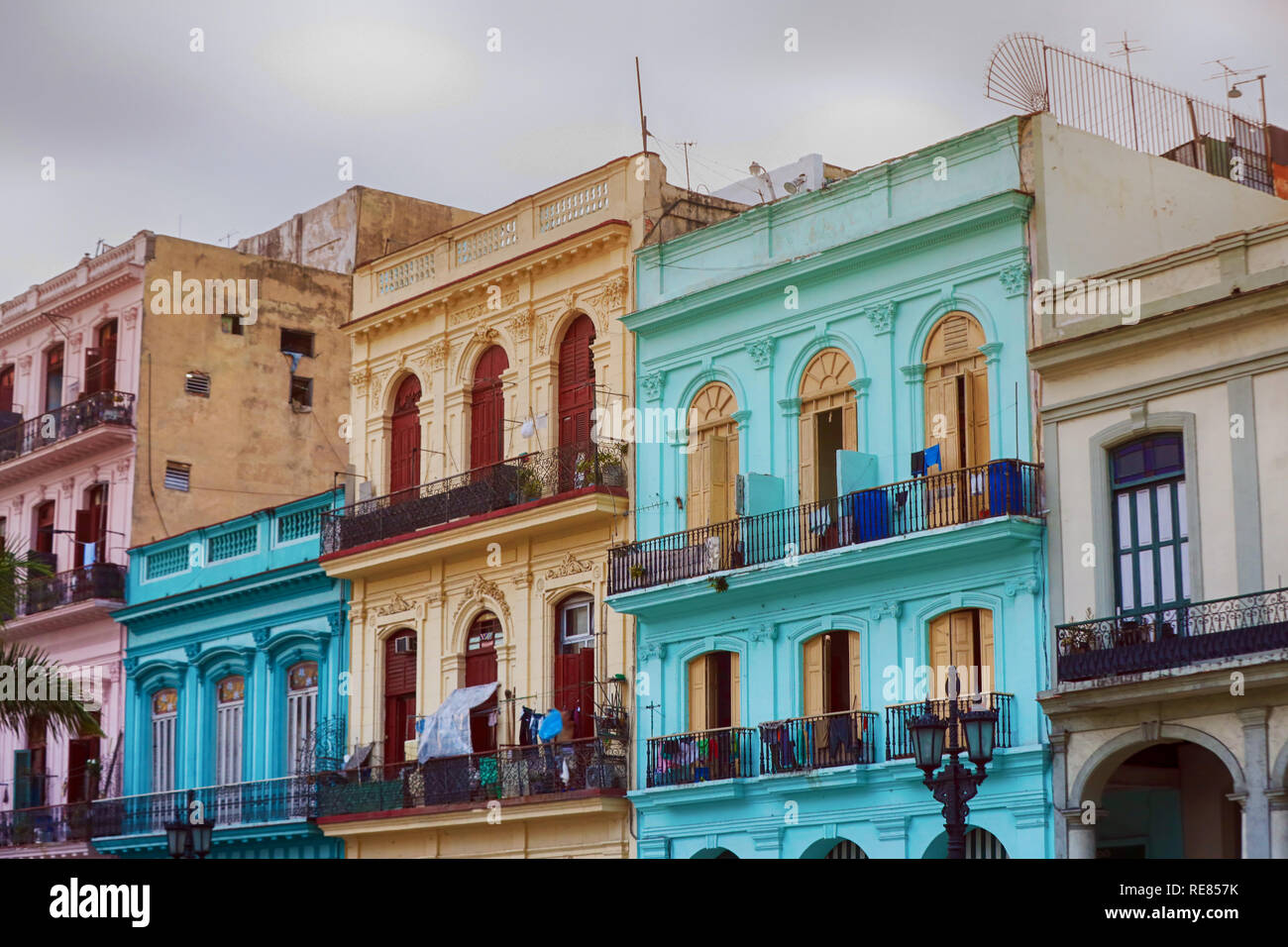 Old living colorful houses across the road in the center of Havana, Cuba Stock Photo