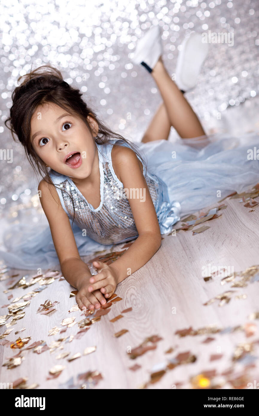 little girl in blue dress sitting on the floor with confetti Stock ...