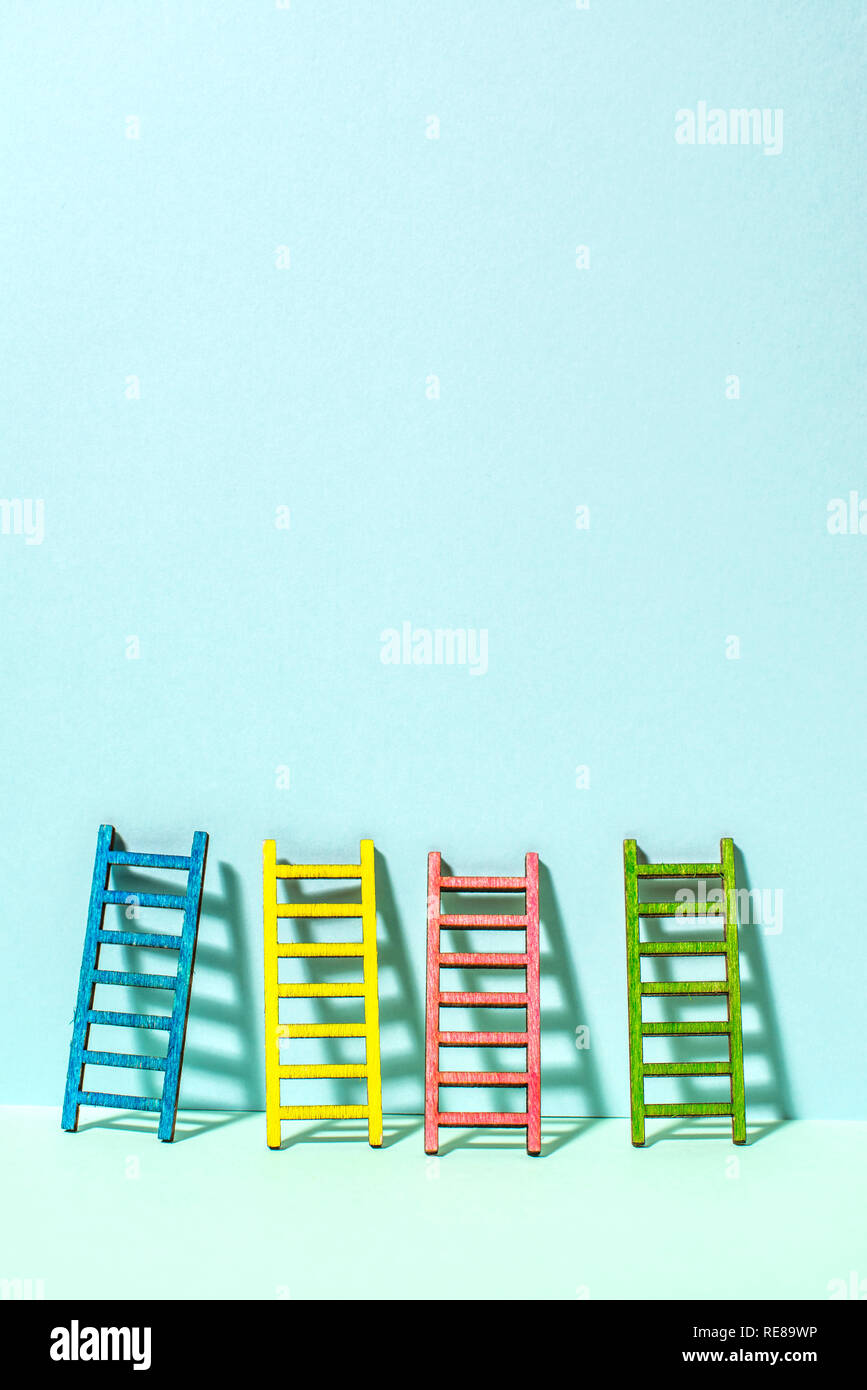 Multicoloured ladders on wall. Pastel tones. Concept for success and growth. Business metaphors. Stock Photo