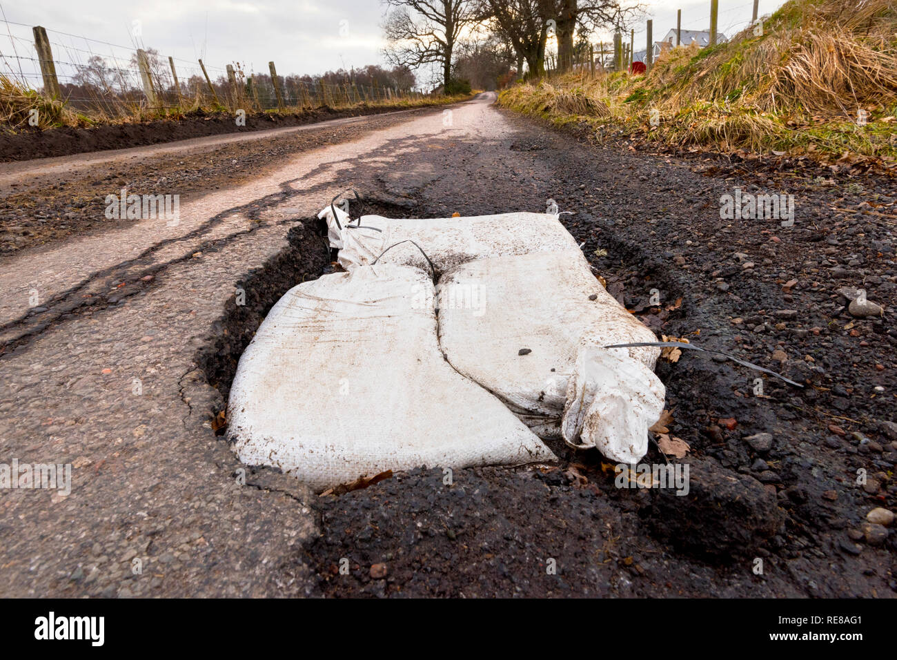 Pot Holes on single track road near Moniack, Inverness. Stock Photo