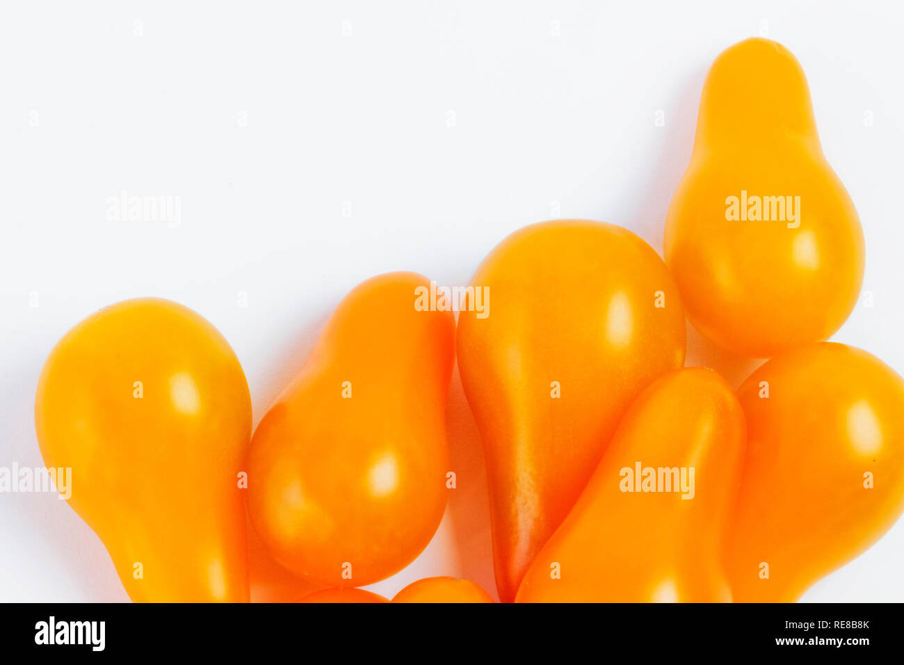 Yellow tomatoes  on a white background ,pear shape tomato , studio shot , horizontal composition Stock Photo