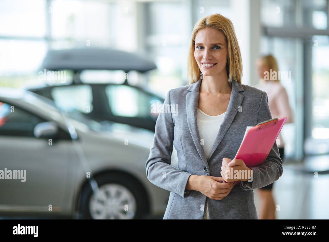 Picture of professional salesperson working in car dealership Stock