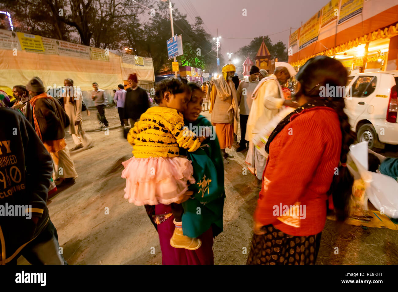 Evening,scene,at Gangasagar ,Pilgrim,transit area,mother,baby daughter,an anxious moment , another female,in red sweater,Kolkata,India. Stock Photo