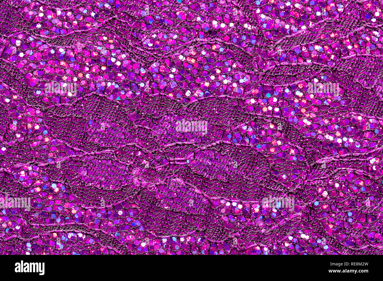 Abstract textured background of pink sequins and lace Stock Photo