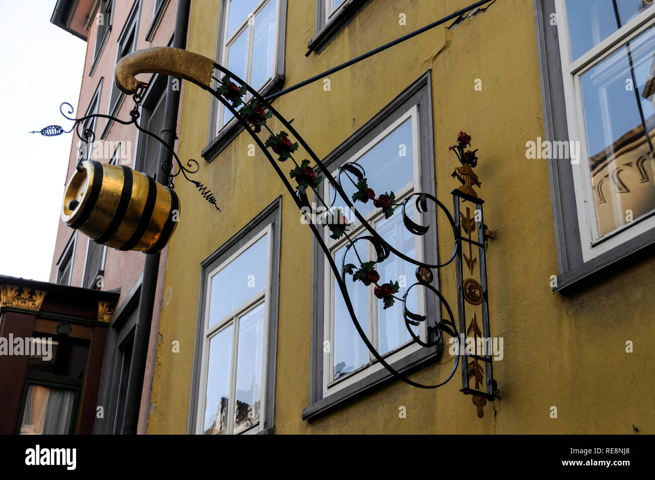 A goldsmith's shop sign with a metal beer barrel in the old quarter of St. Gallen in northeastern Switzerland. Stock Photo