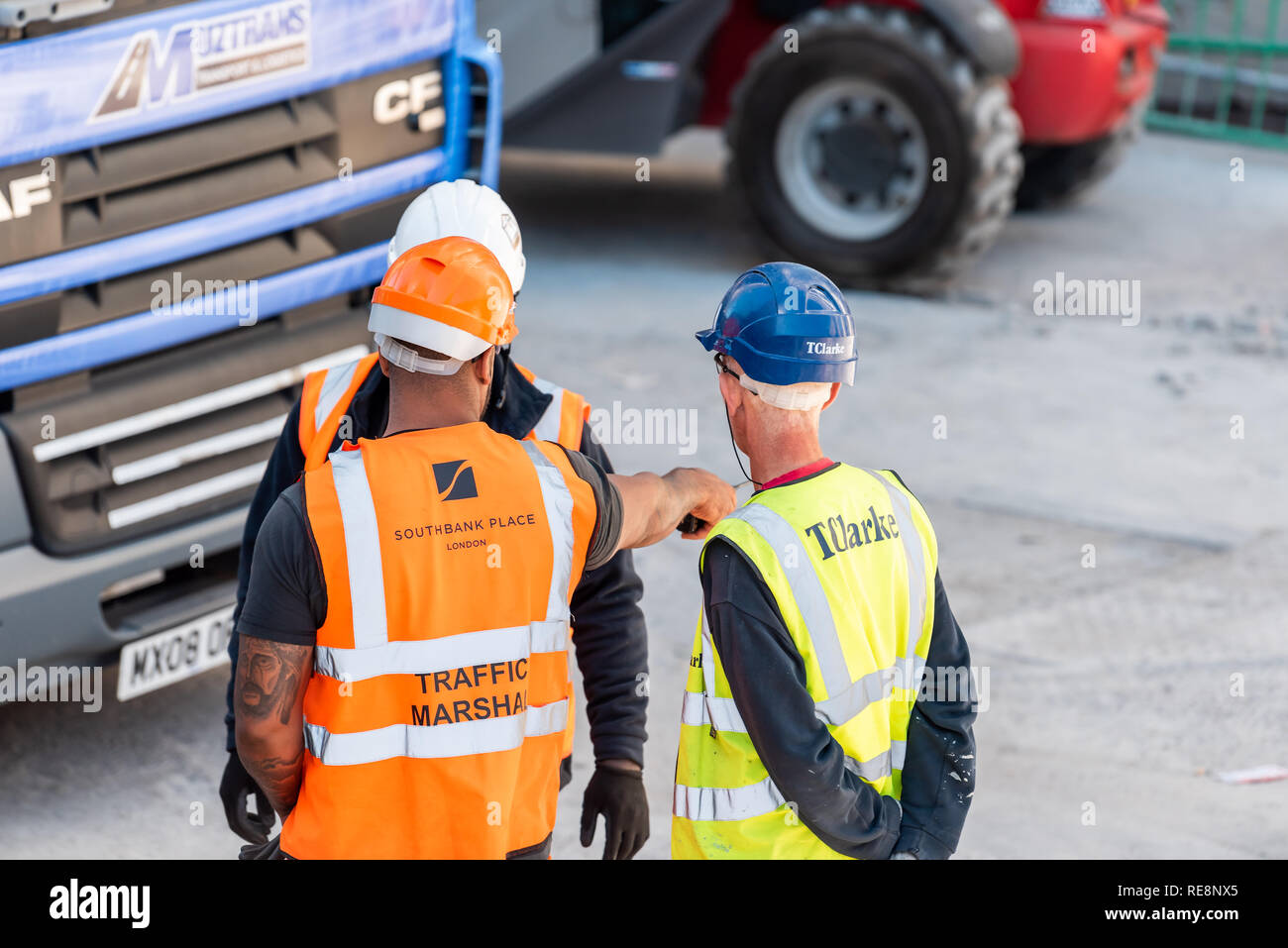 London, UK - June 22, 2018: Group of three construction worker with neon  yellow orange uniform vest clothing high angle view on city street Stock  Photo - Alamy