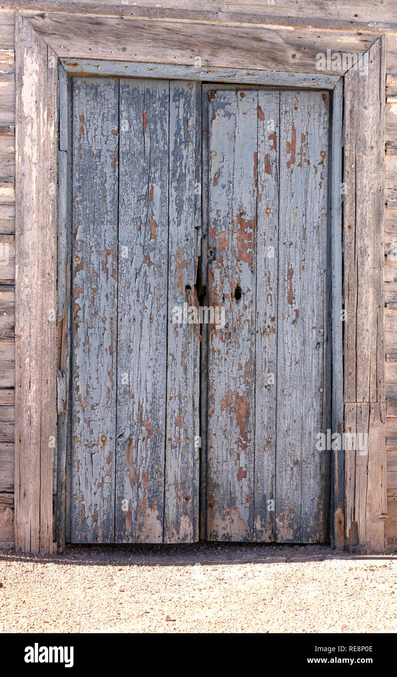 old blue wooden door in a very worn gray wooden wall Stock Photo - Alamy