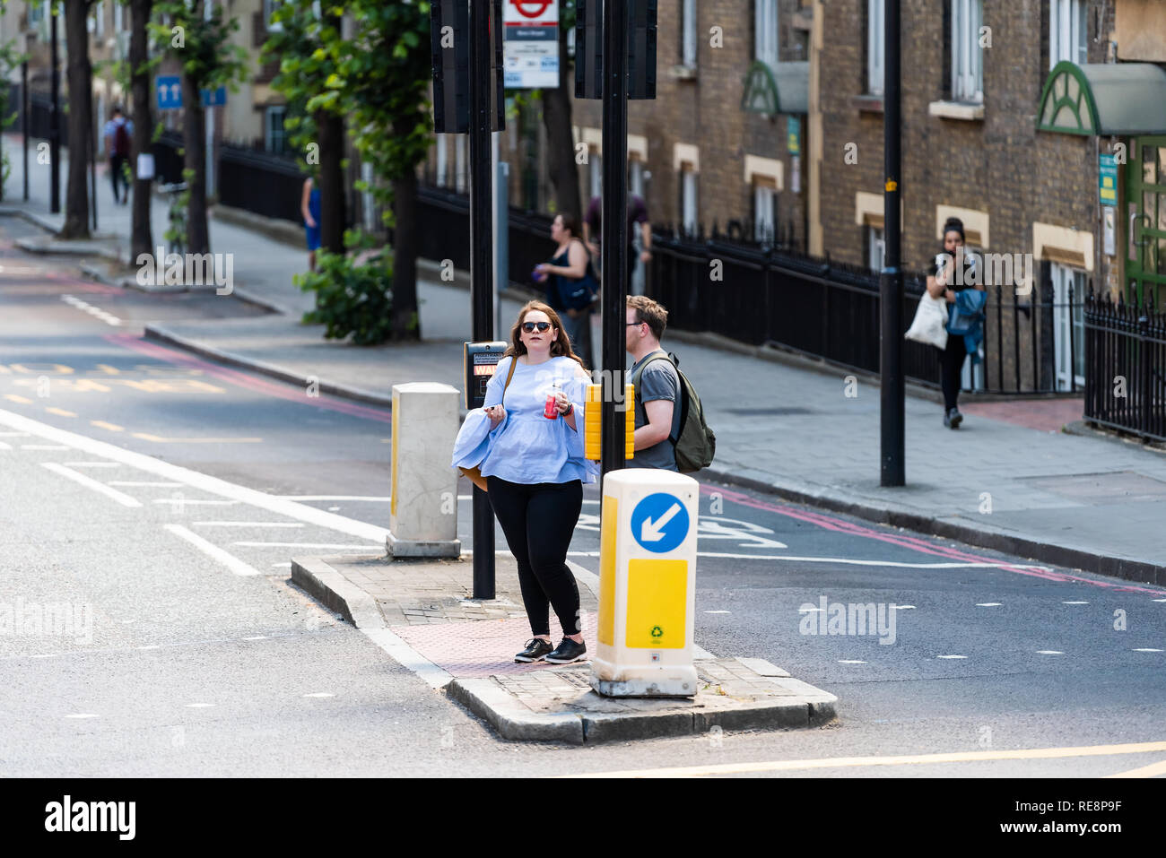 London, UK - June 22, 2018: High angle view of street with people standing waiting to cross road in city Stock Photo