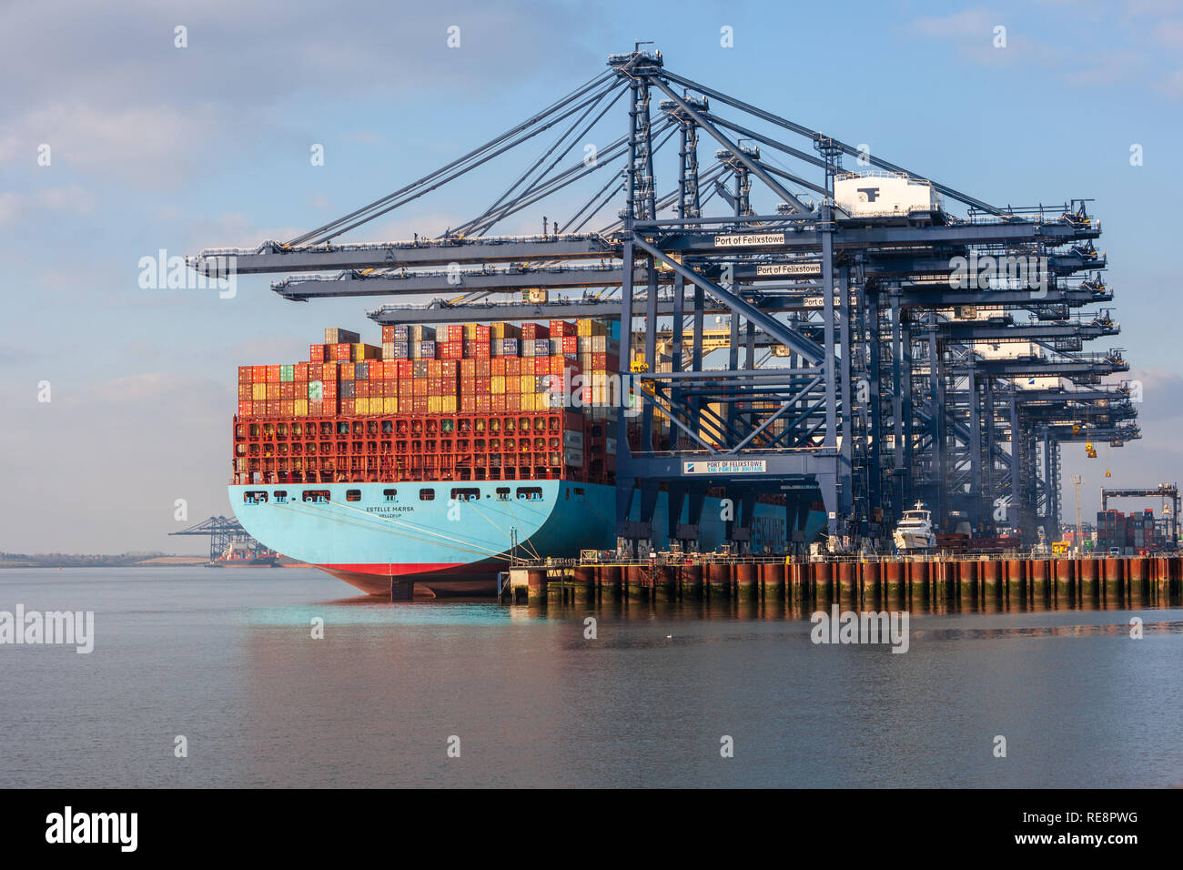 view of massive maersk container ship unloading containers freight at felixstowe port suffolk Stock Photo