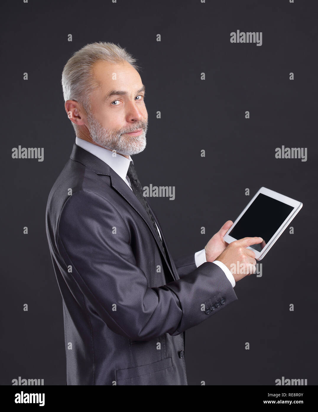 modern businessman using digital tablet.isolated on black background Stock Photo