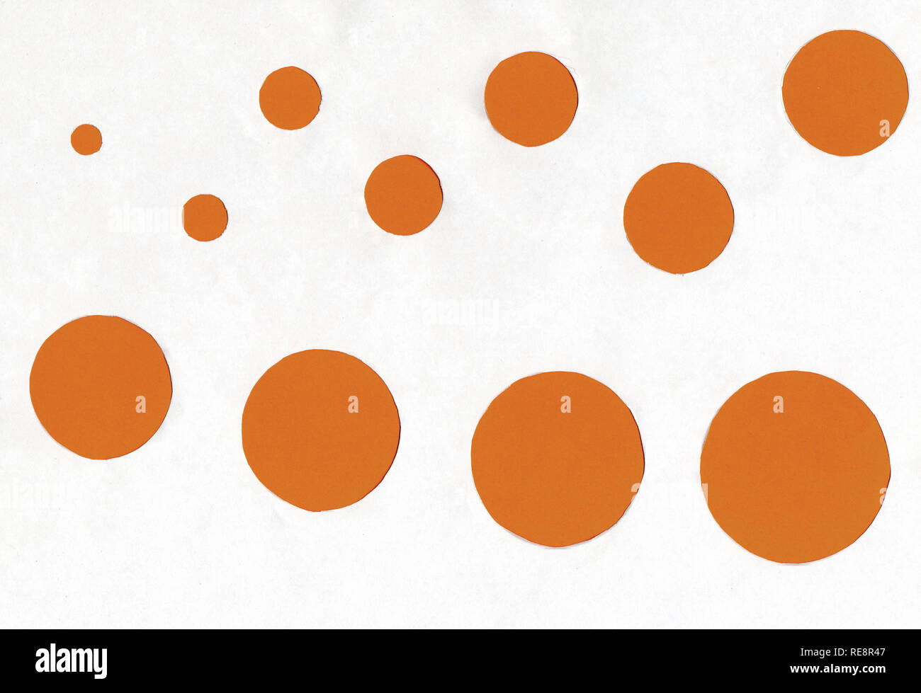 small and large orange circles on a white background. Stock Photo