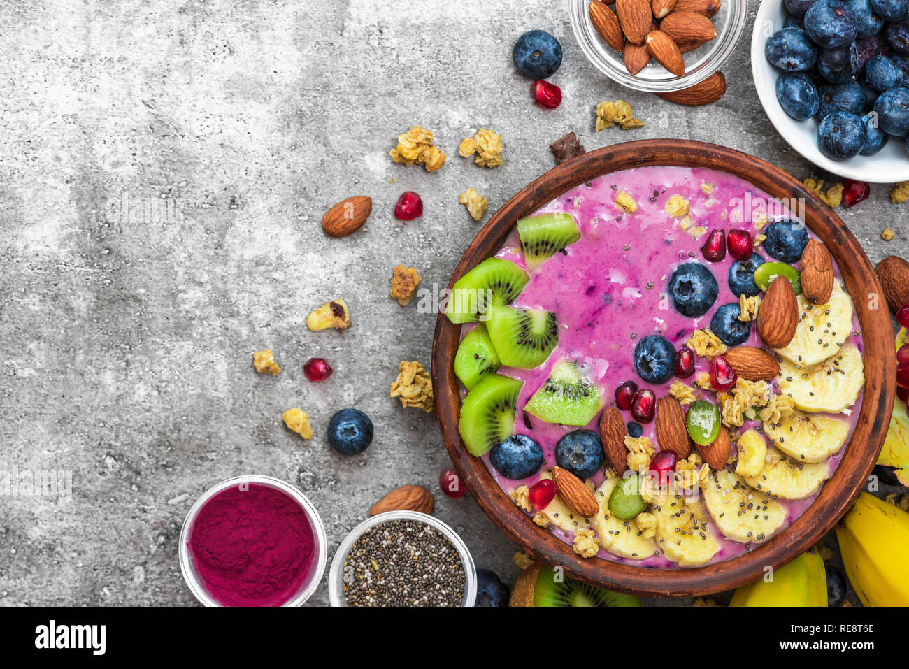 Healthy breakfast. acai smoothie bowl with blueberry, fruits, granola, almonds, pumpkin and chia seeds. detox food concept. top view with copy space Stock Photo