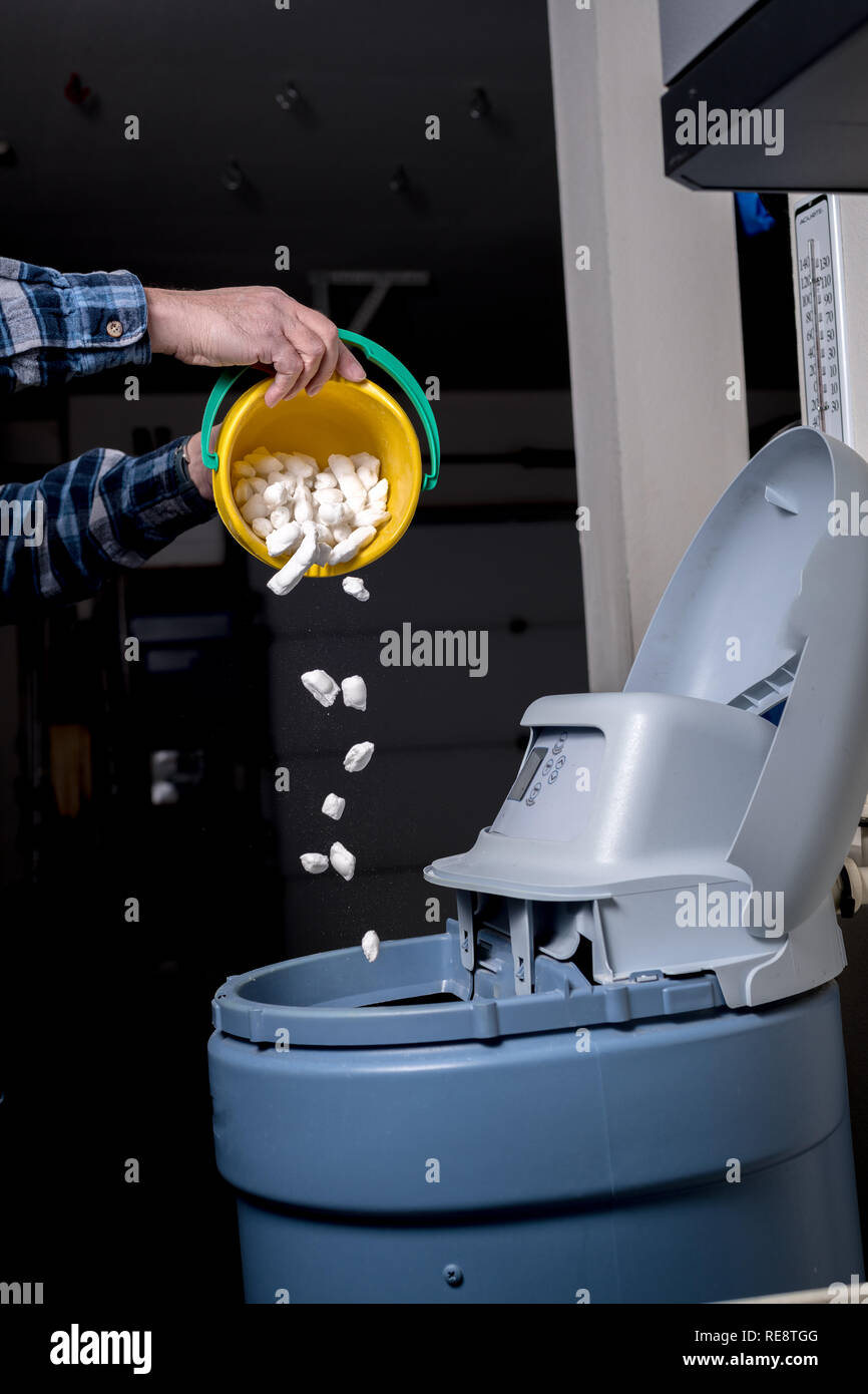 Scheduled salt is added to a water softener as maintenance determines