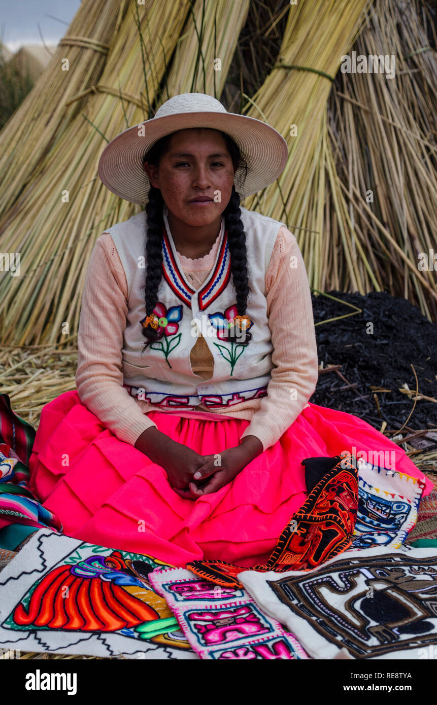 Native south american woman on floating reed island wearing traditional south american clothes (Andean clothing) Stock Photo