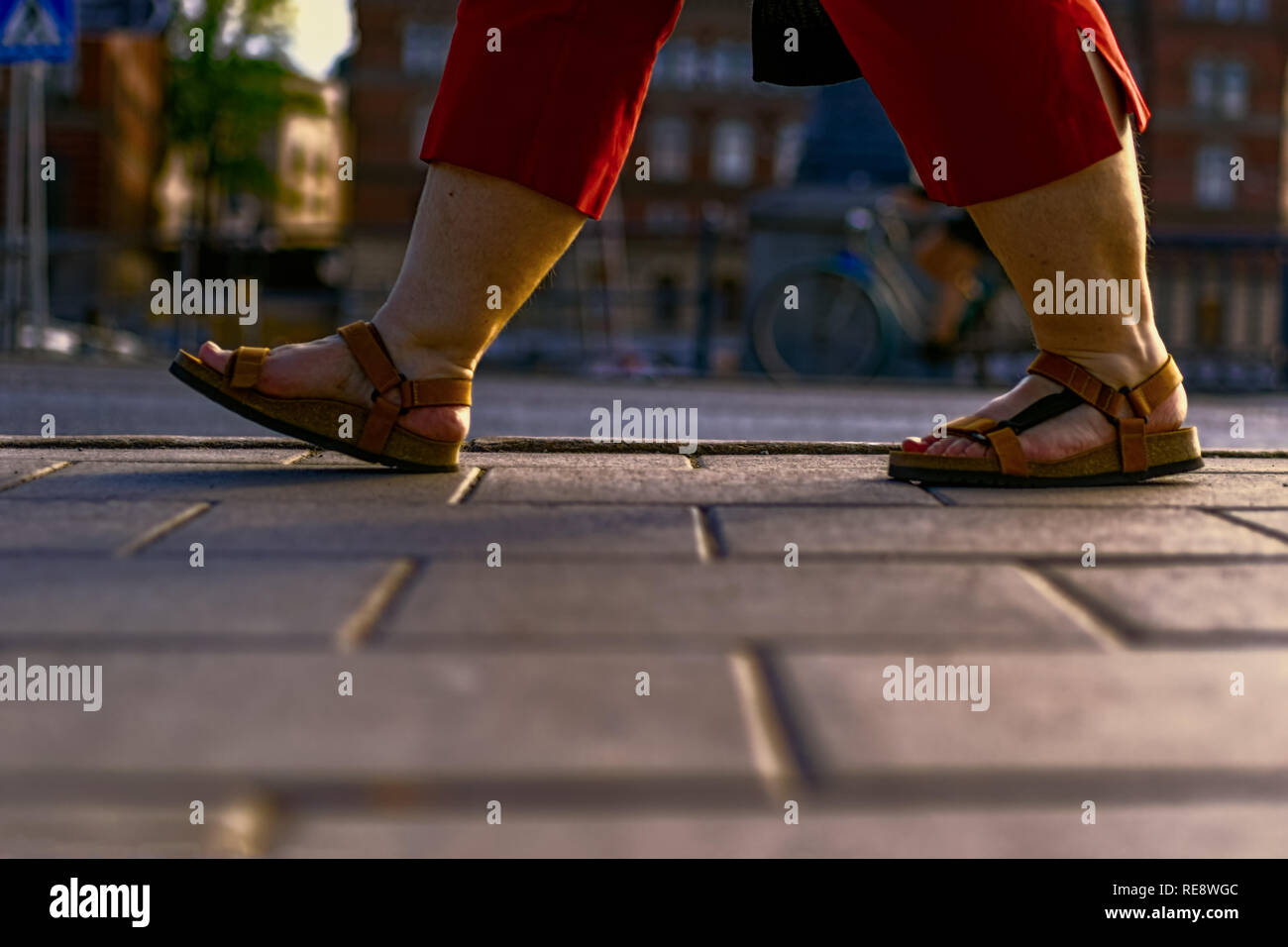 plus size woman walking on sidewalk in summer Stock Photo Alamy
