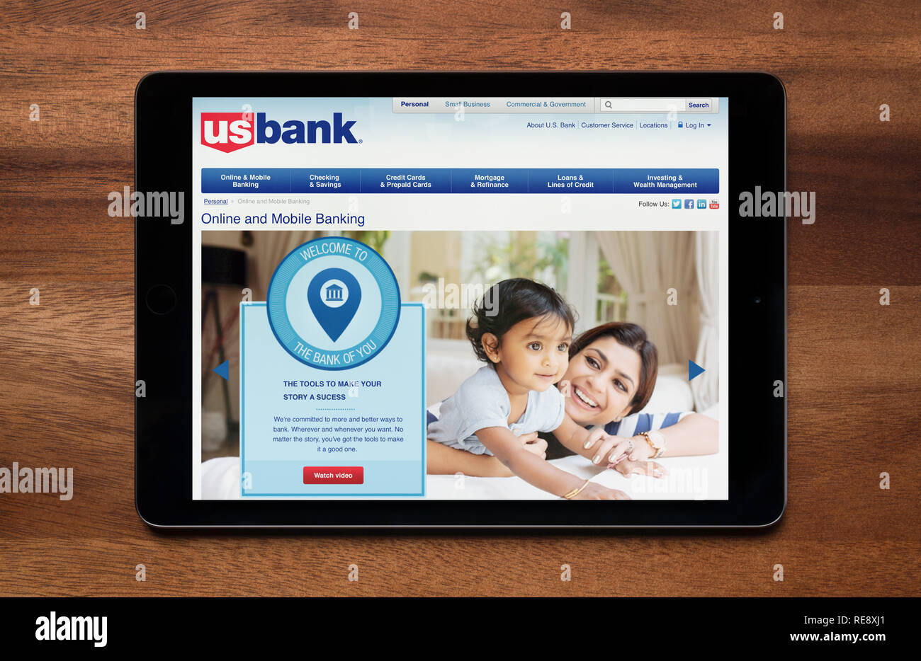 The website of US Bank is seen on an iPad tablet, which is resting on a wooden table (Editorial use only). Stock Photo