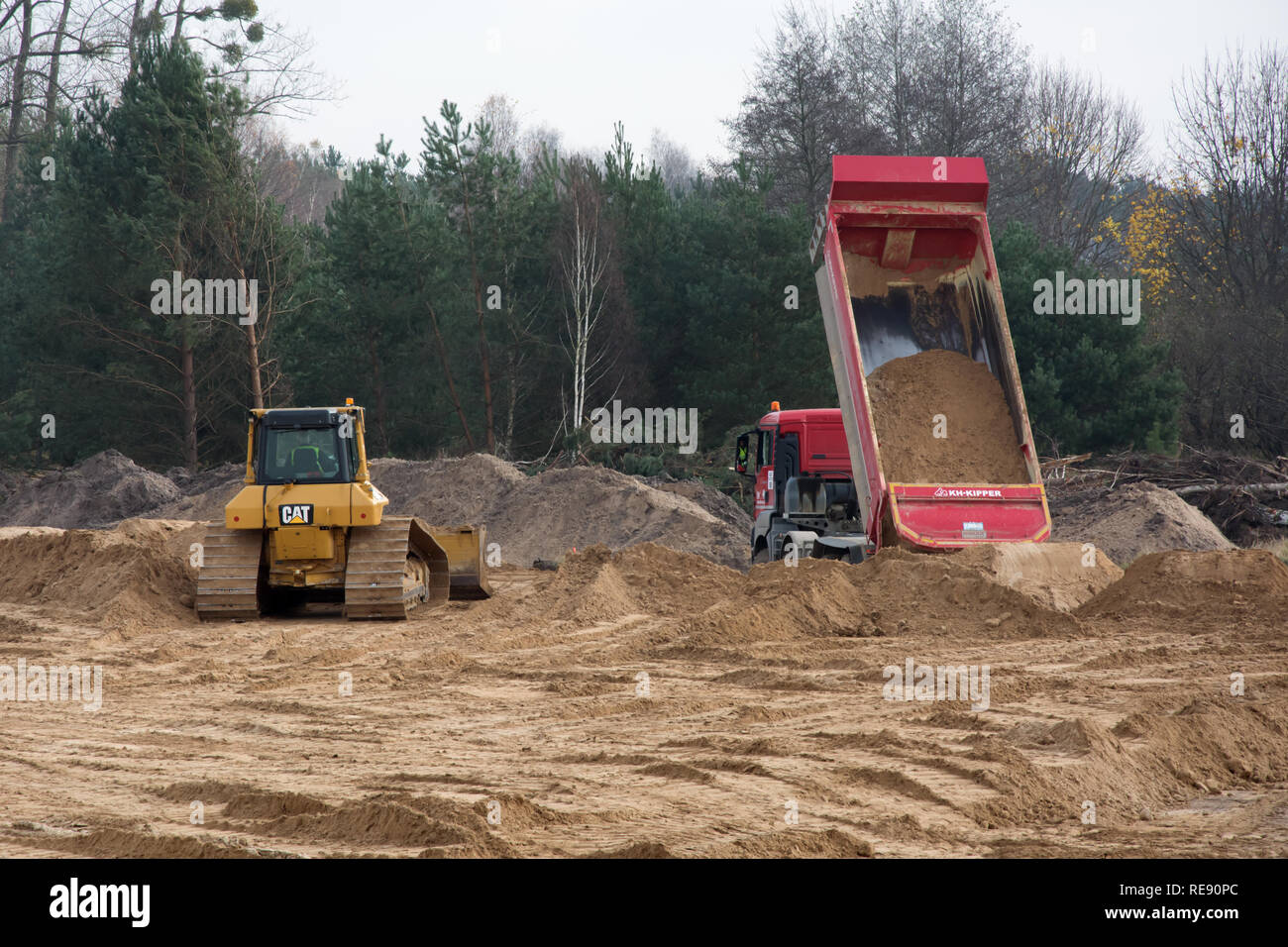 KRUSZYN KRAJENSKI, KUJAWSKO-POMORSKIE/POLAND - NOVEMBER 13, 2017 - S5 construction site with CAT earth mover and man kipper dumper discharging its loa Stock Photo