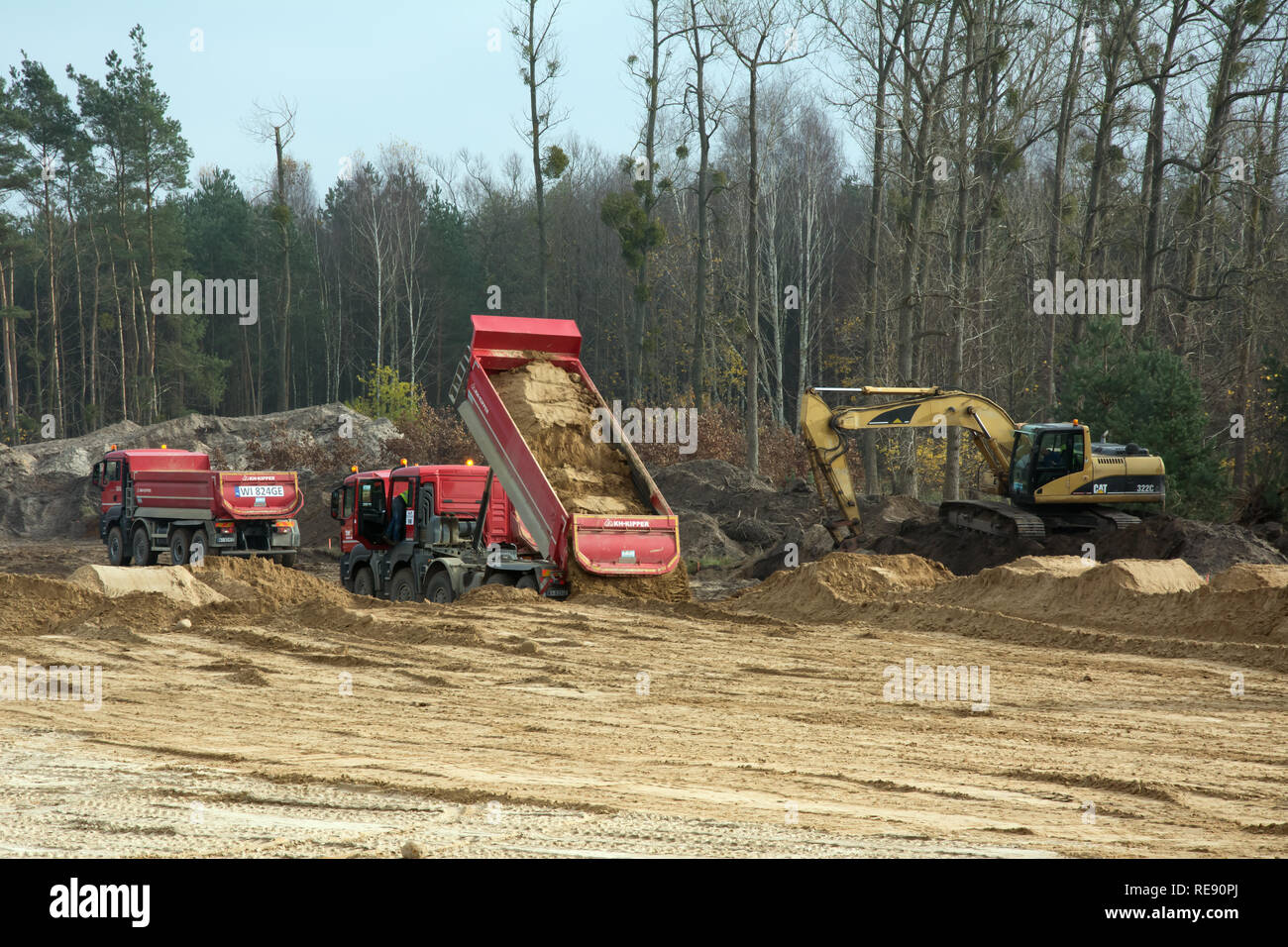 KRUSZYN KRAJENSKI, KUJAWSKO-POMORSKIE/POLAND - NOVEMBER 13, 2017 - S5 construction site with three man kipper dumpers and excavator Stock Photo