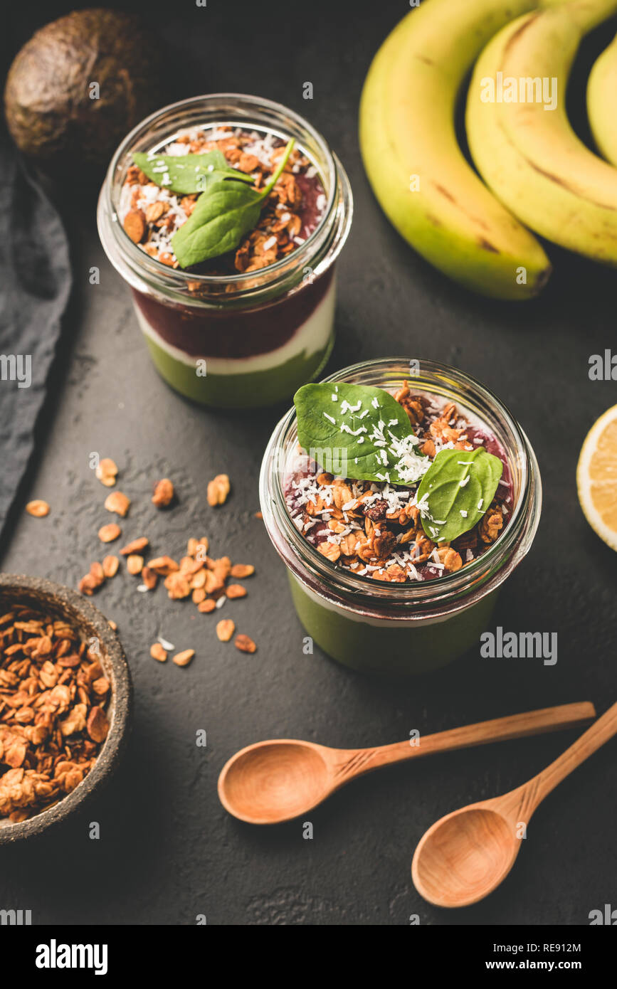 Healthy breakfast parfait in jar with granola and banana. Top view ...