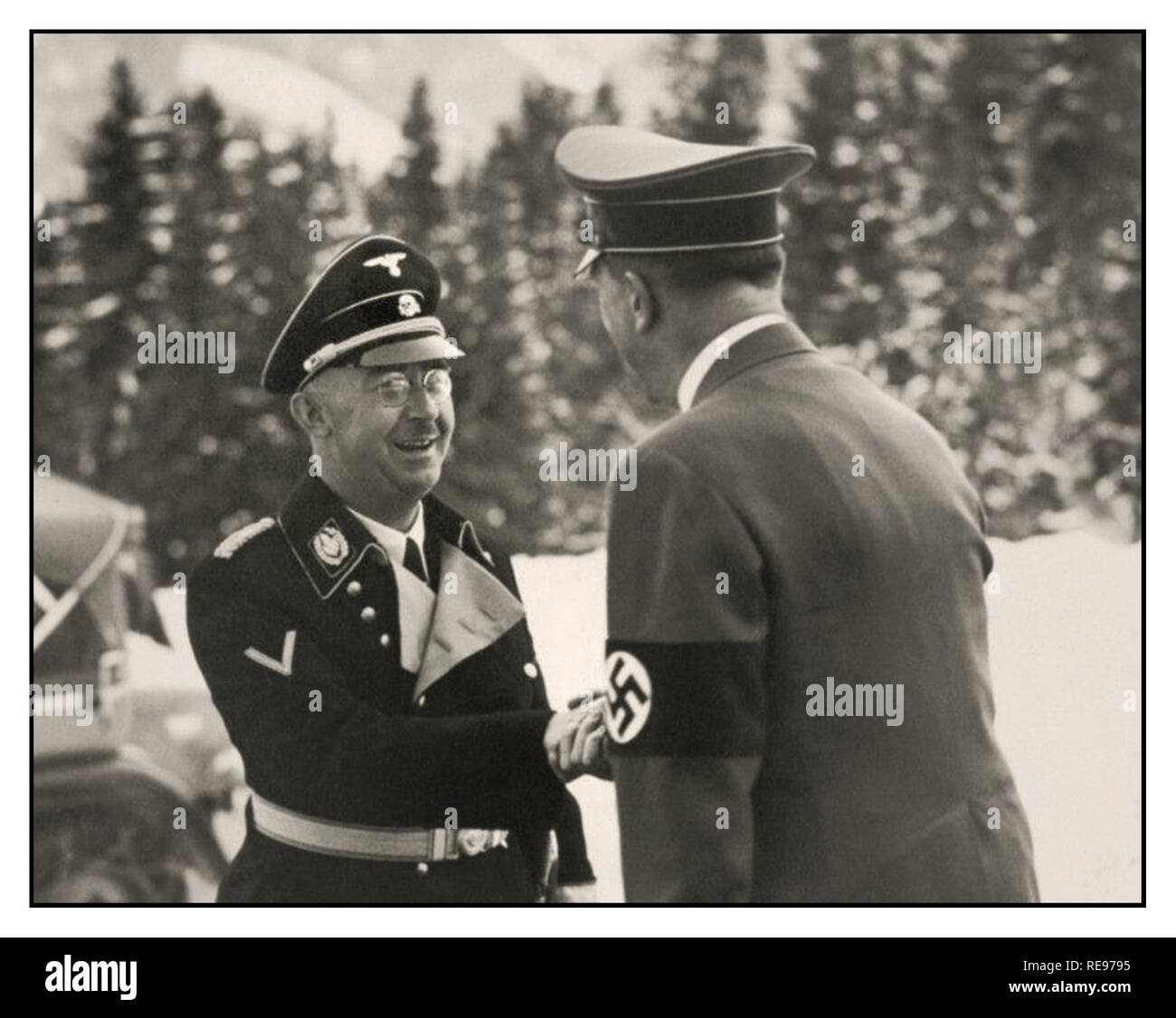 1939 Heinrich Himmler Reichsführer of the Schutzstaffel (Protection Squadron; SS), and a leading member of the Nazi Party (NSDAP) of Germany, greets Fuhrer Adolf Hitler at The Berghof near Berchtesgaden  Obersalzberg Bavaria Germany in winter Stock Photo