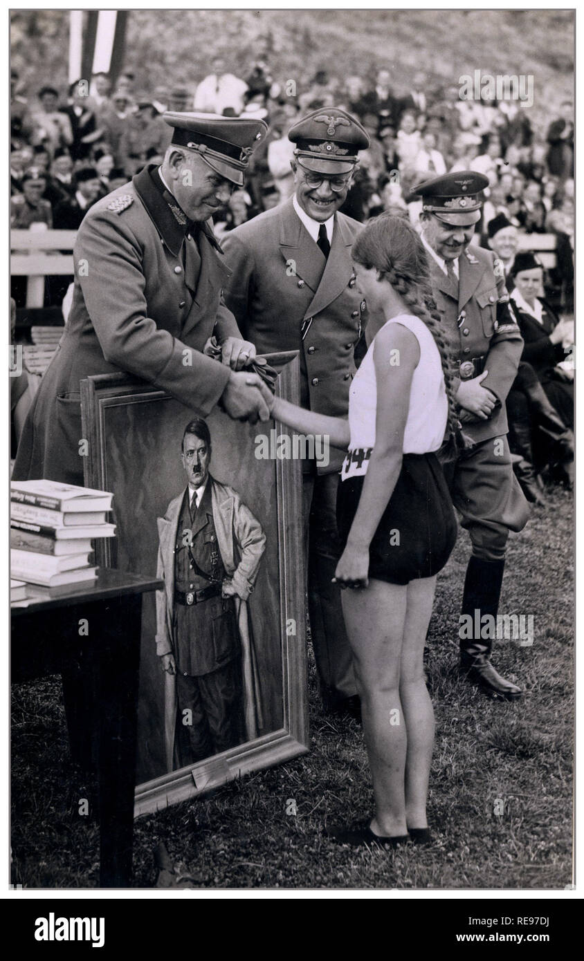 Archive Sports Day in Holland with Nazi Officers handing out the prizes Lieutenant General Otto Schumann commander-in-chief of the Ordnungspolizei in the Netherlands, Reich Commissioner Arthur Seyss-Inquart and General Commissioner Fritz Schmidt. General Schumann hands a sportswoman a portrait of Adolf Hitler as a prize. 21 July 1941 Stock Photo