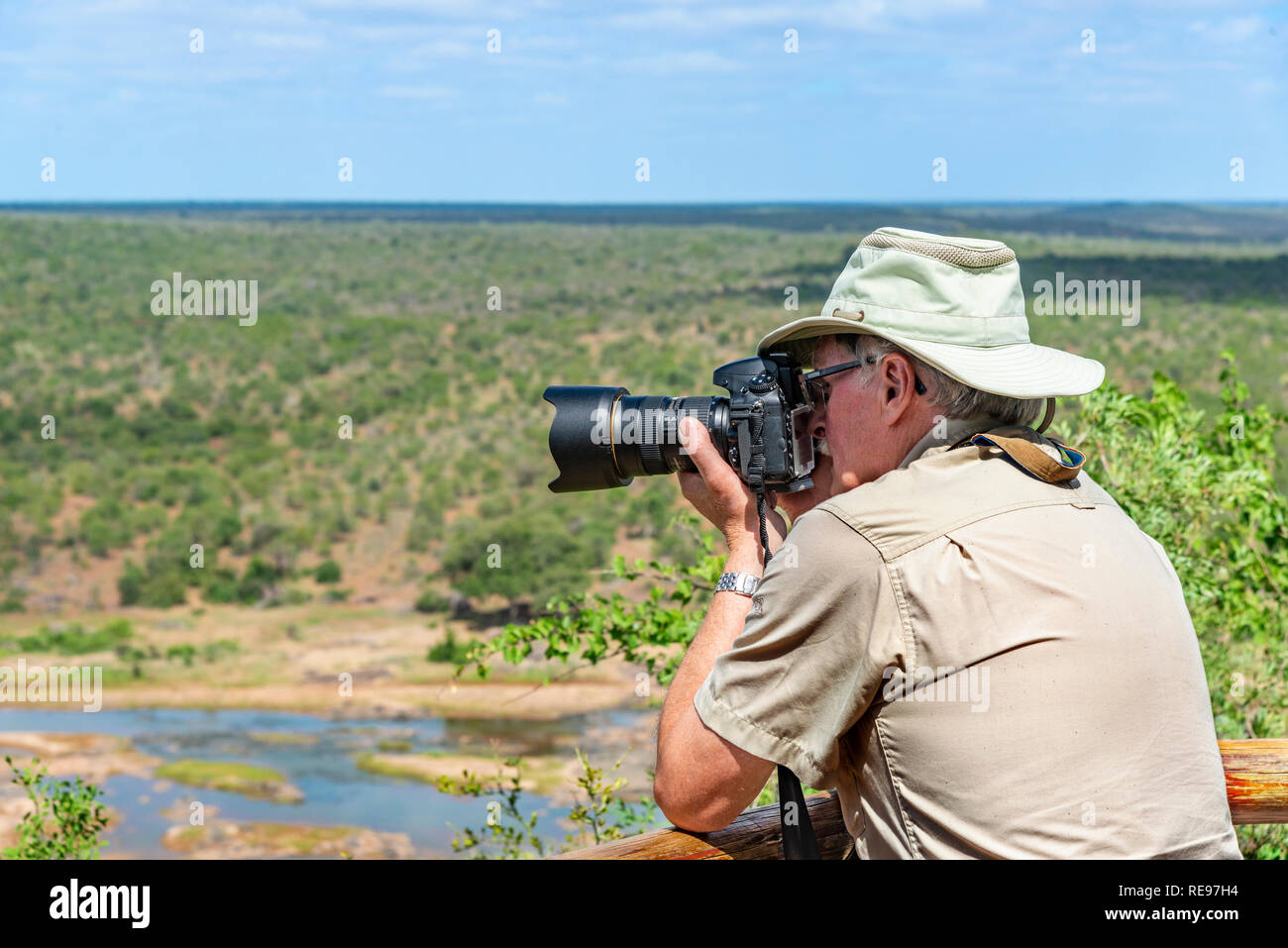 Male photographer on photoshoot overlooking the Olifants River, Kruger National Park, South Africa Stock Photo