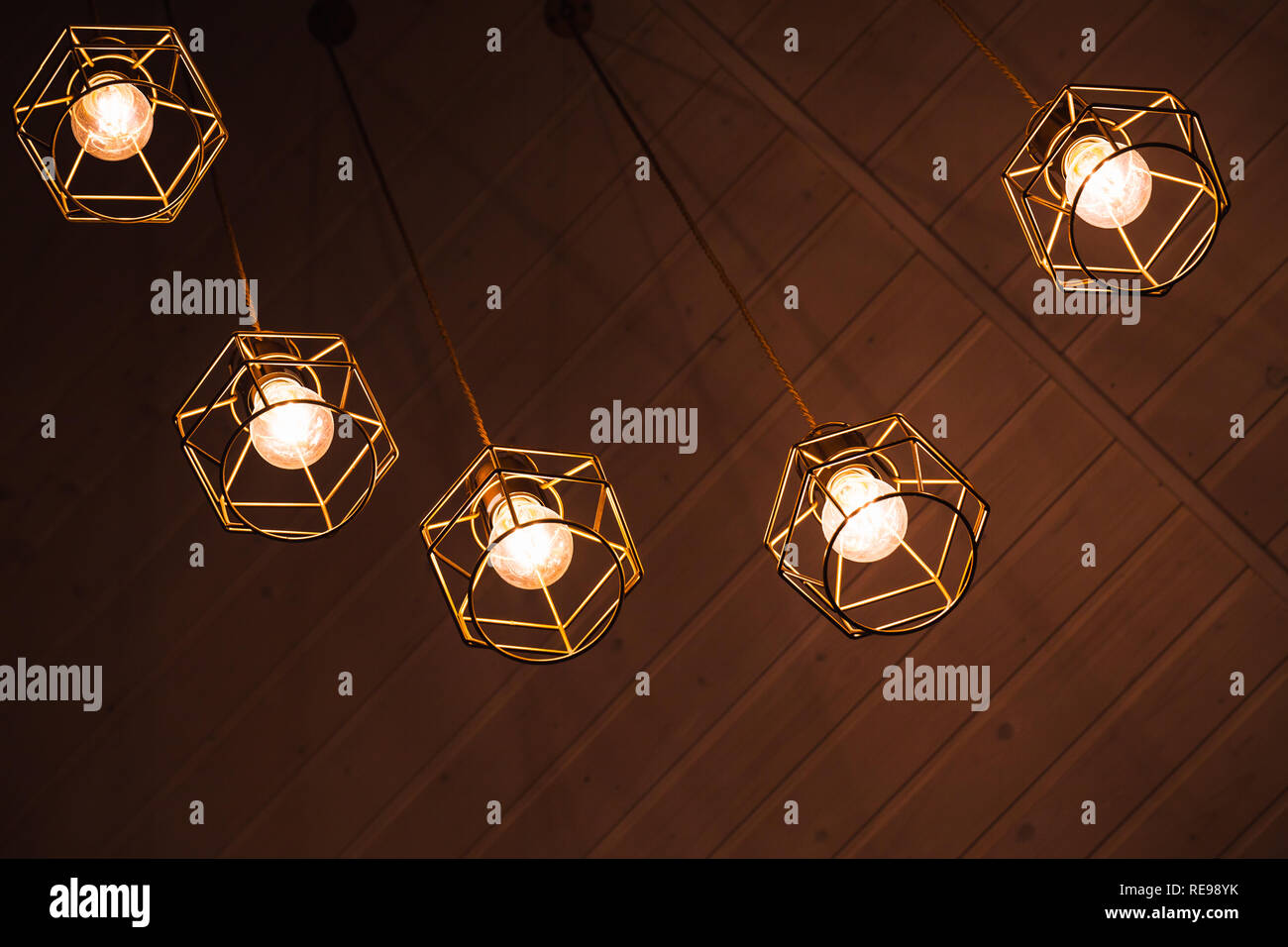 Spider type of ceiling chandelier with hanging bulb lamps, yellow LED