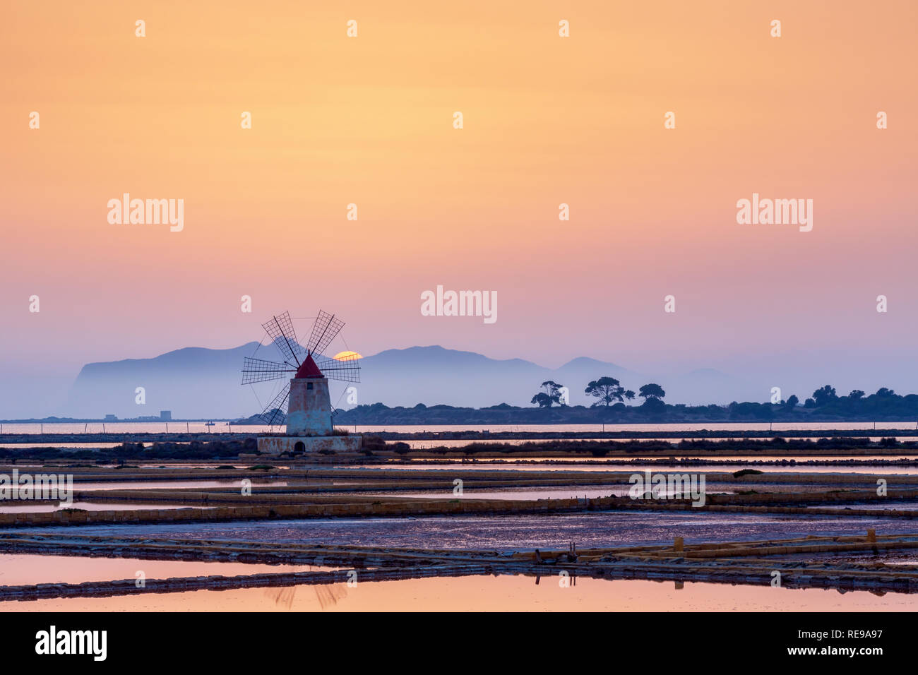 Sunset at the old salt works in the Laguna dello Stagnone near Trapani, Sicily, Italy Stock Photo