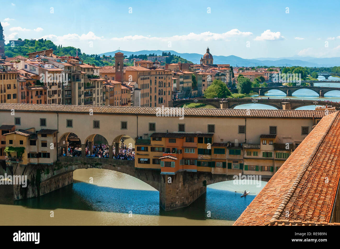 View of the Ponte Vecchio, a medieval stone bridge over the River Arno with other bridges in the background in the centre of Florence, Italy Stock Photo