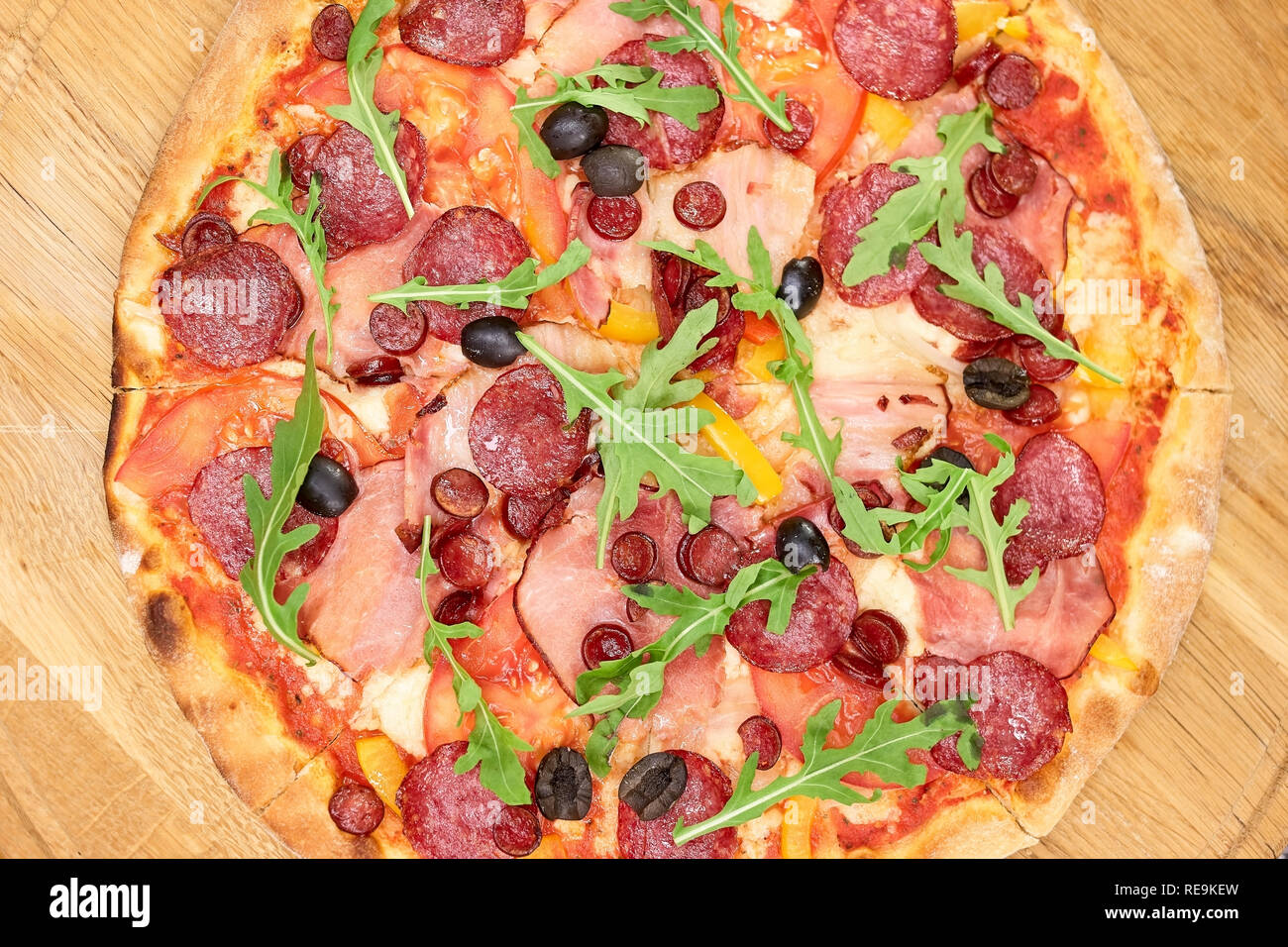 Baked sliced salami pizza, top view. Top view on pizza with cold meats