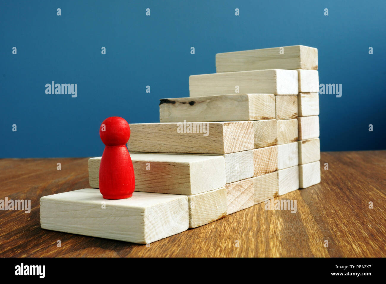 Up the career ladder with wooden blocks as stairs. Stock Photo