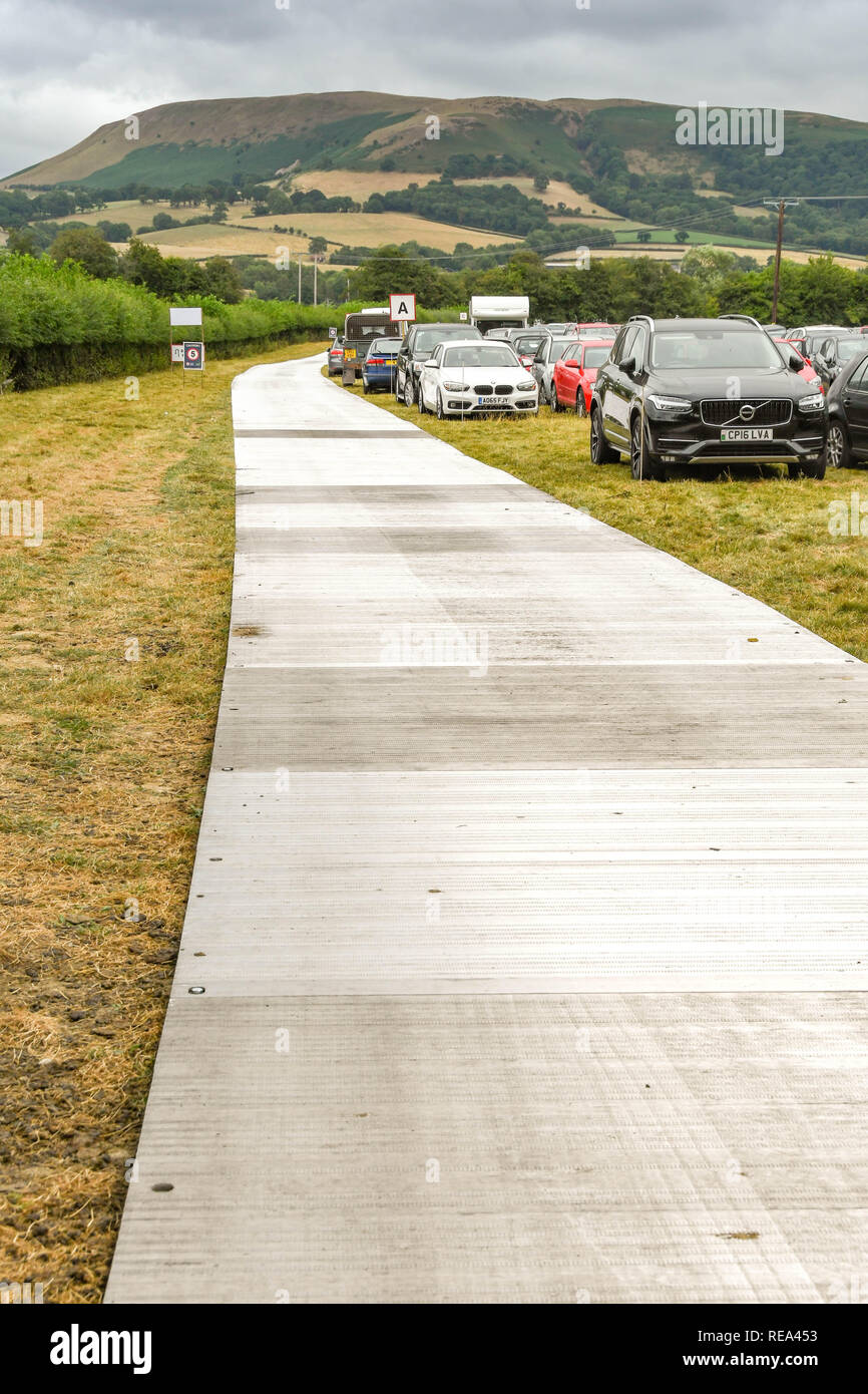 BUILTH WELLS, WALES - JULY 2018: Metal plates placed on a field being used as a public car park for an agricultural show. Stock Photo