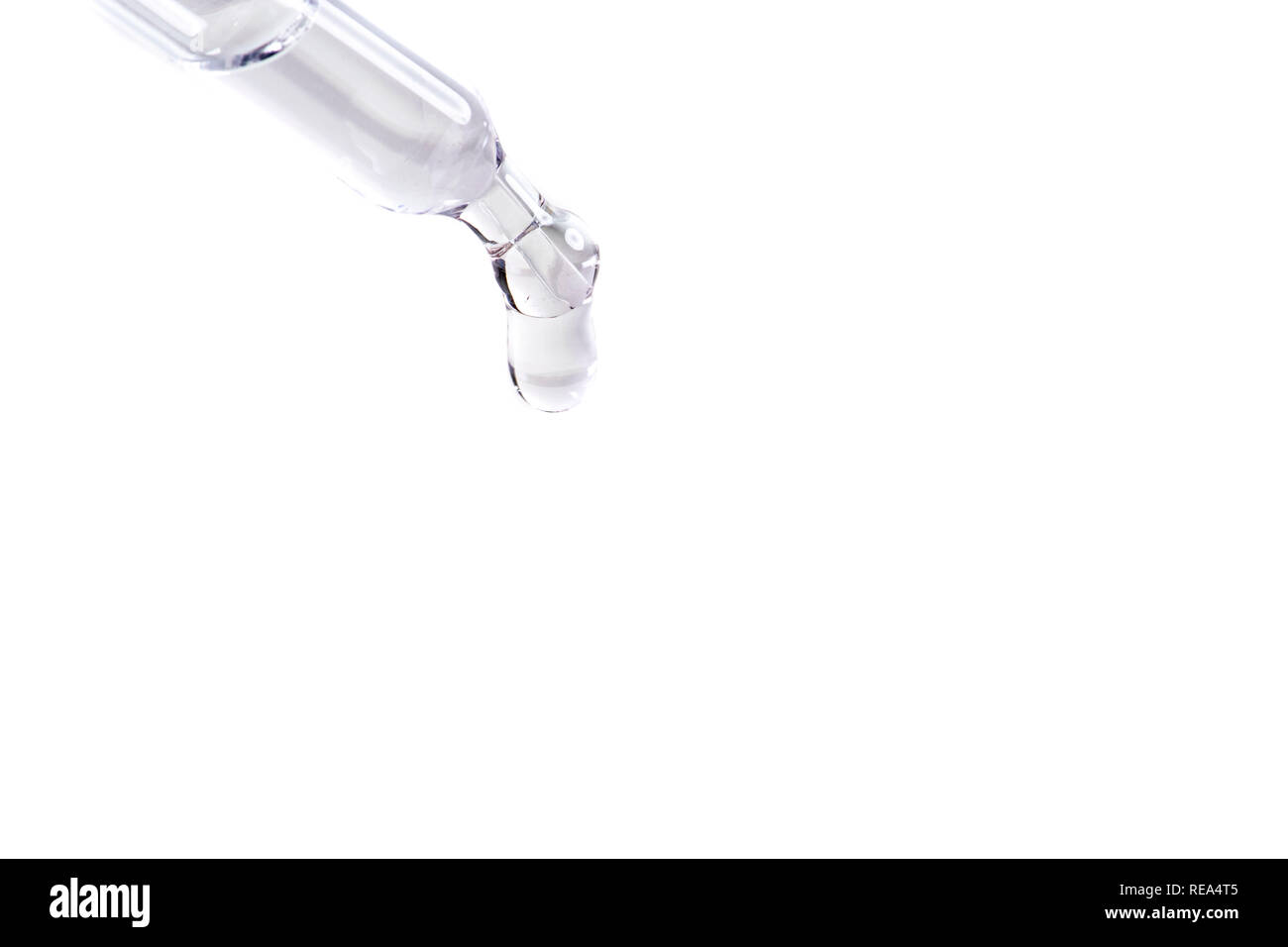 waterdrop with little waves from a pipette Stock Photo