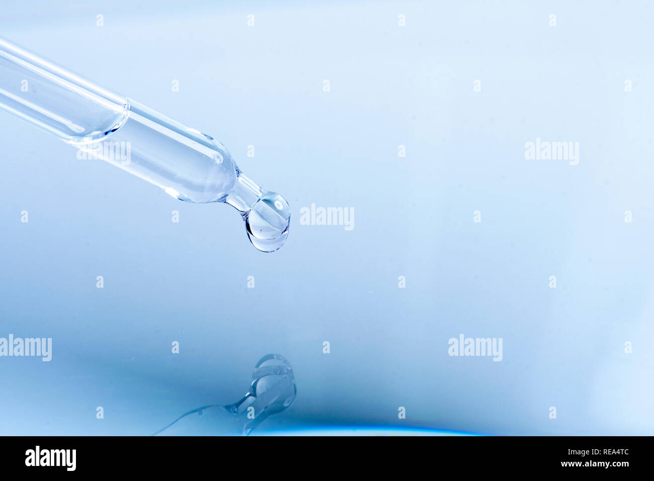 waterdrop with little waves from a pipette Stock Photo