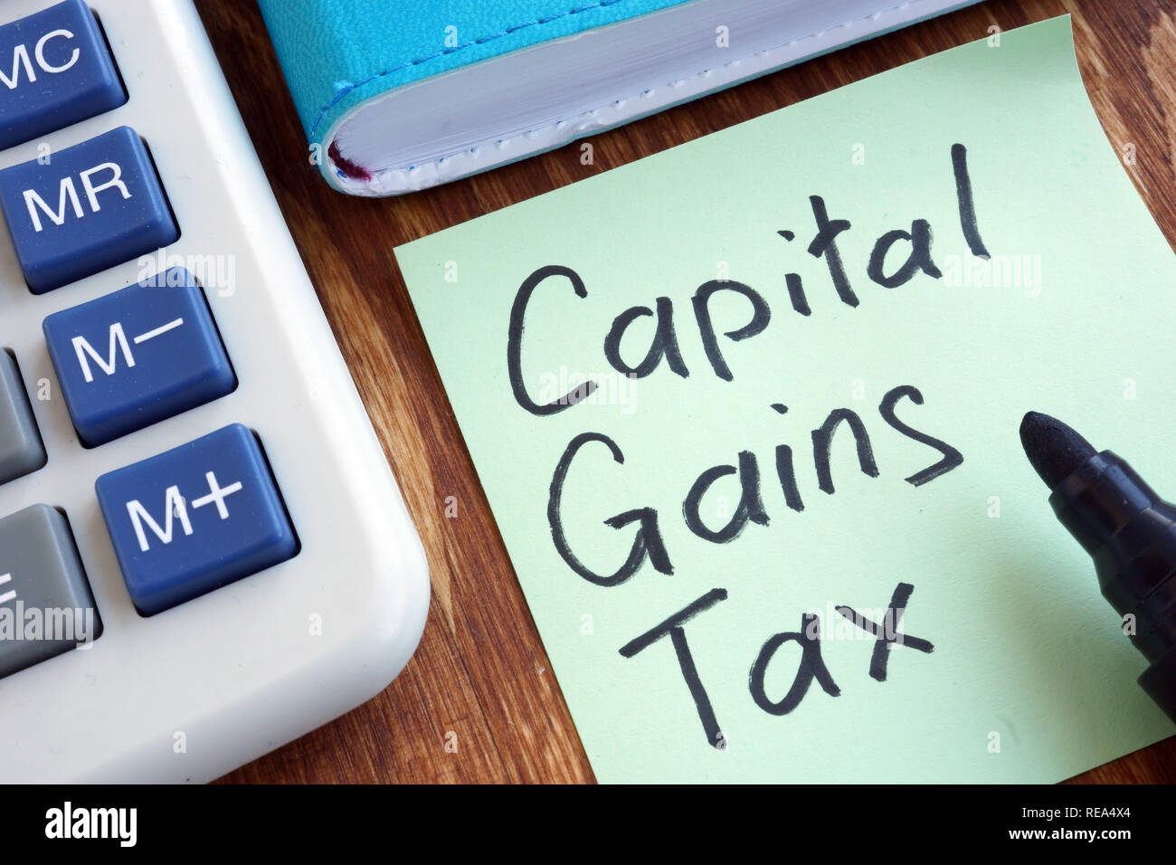 CGT Capital Gains Tax. Memo stick and calculator Stock Photo Alamy