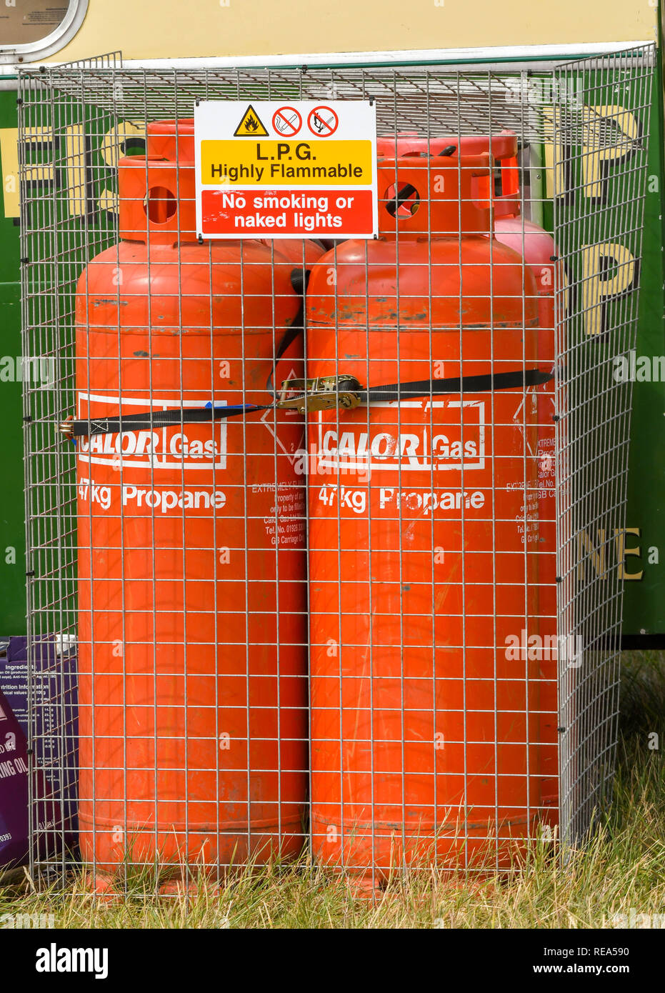 FAIRFORD, ENGLAND - JULY 2018: Can of Pair of propane gas bottles locked in a metal cage at an outdoor event. Stock Photo