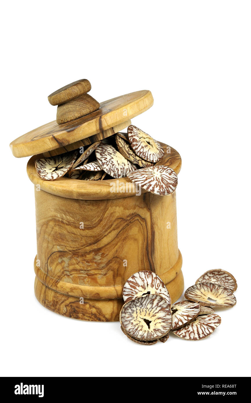 sliced betel nuts in a wooden jar made of olive wood isolated on white background Stock Photo
