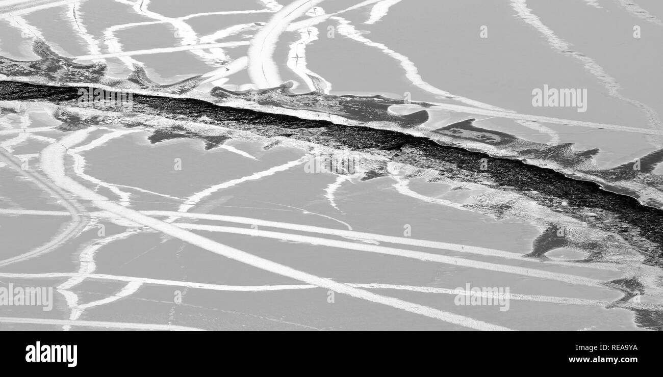 Tracks - Gaps and cracks form in thin surface ice on Emerald Bay. Lake Tahoe, California, USA Stock Photo