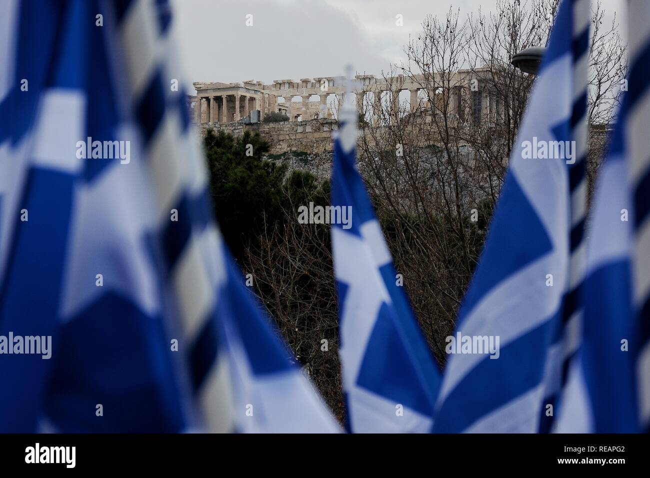 Acropolis of Athens seen through several Greek flags during the 'Macedonia is Greek' rally, which took place on Syntagma Square. People from all parts of Greece protested against the Prespa agreement between Greece and FYROM, stating that Macedonia is only Greek and demanding a referendum about the agreement. Stock Photo