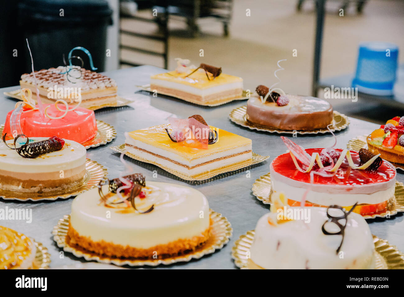 Much Cake many different cakes prepared on the metal table of a food factory ...