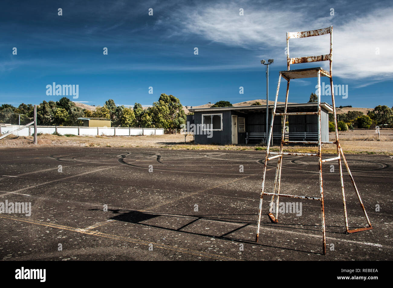 Umpires chair and shed in an abandoned tennis court in rural Victoria Australia Stock Photo