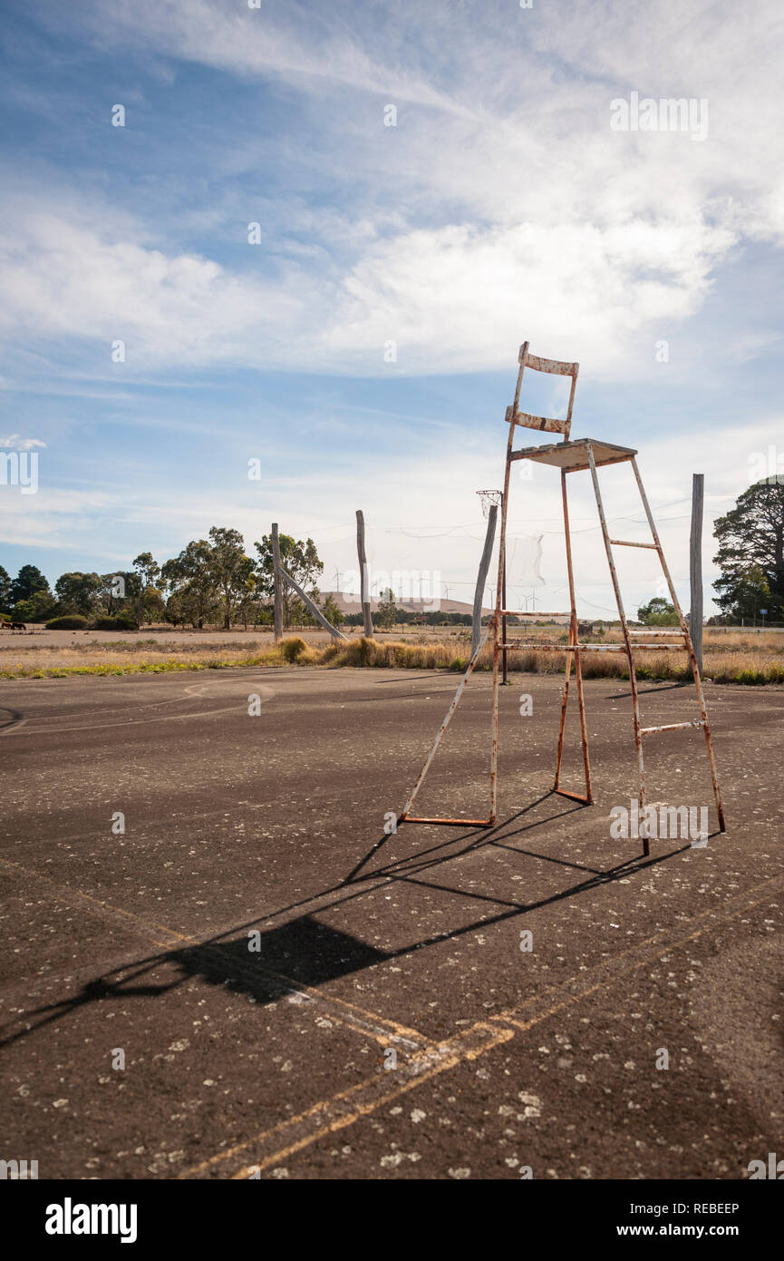 A worn and abandoned umpires chair in a rural Victorian tennis court, Australia Stock Photo