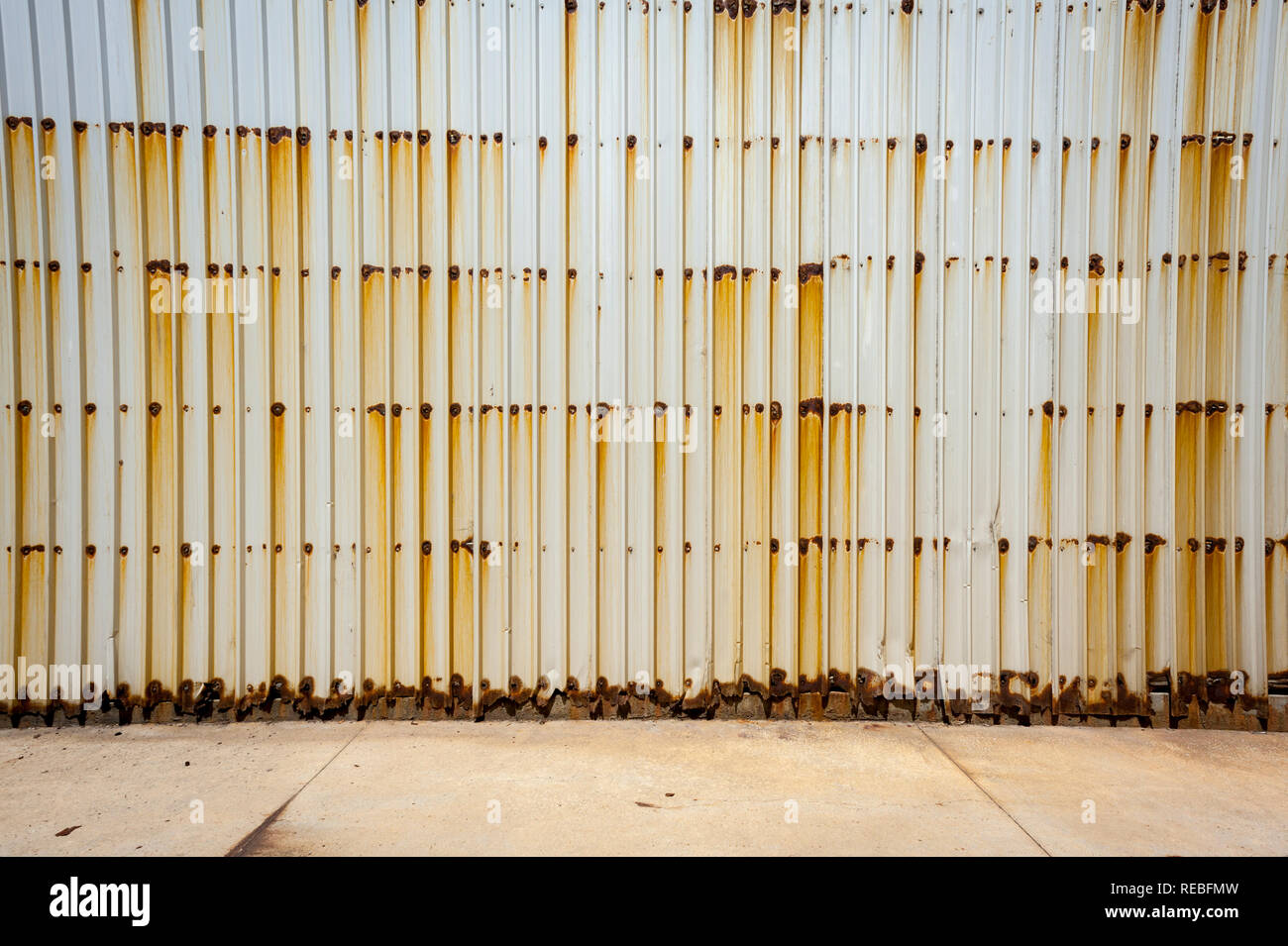 A rusting and streaky corrugated wall with strong vertical line pattern Stock Photo