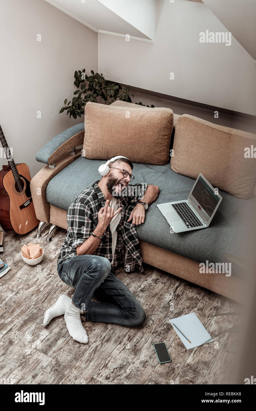 Positive cheerful young man singing a song Stock Photo