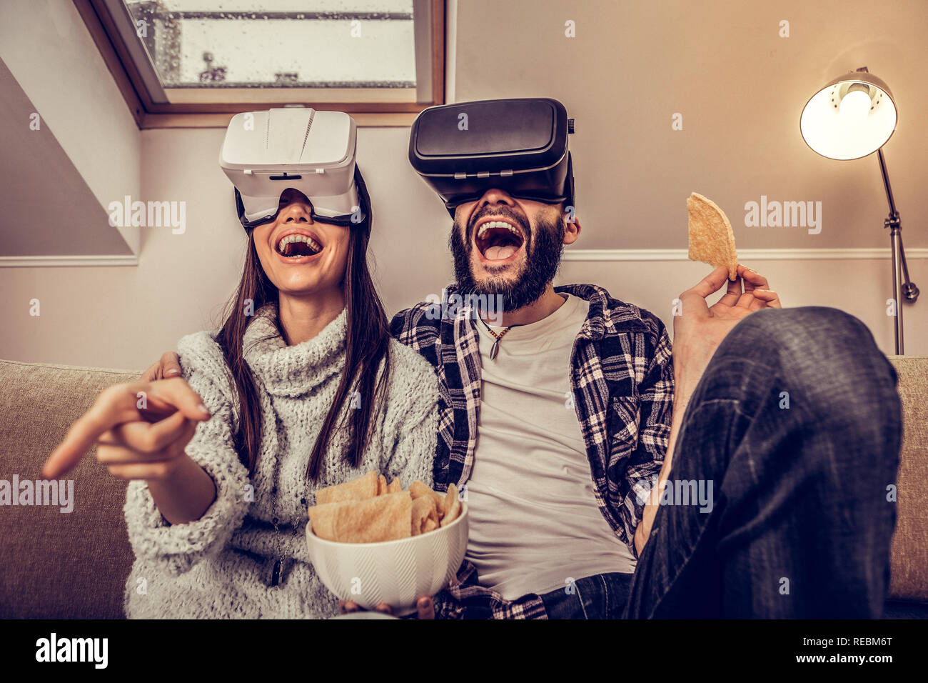 Joyful excited young couple using virtual technology Stock Photo
