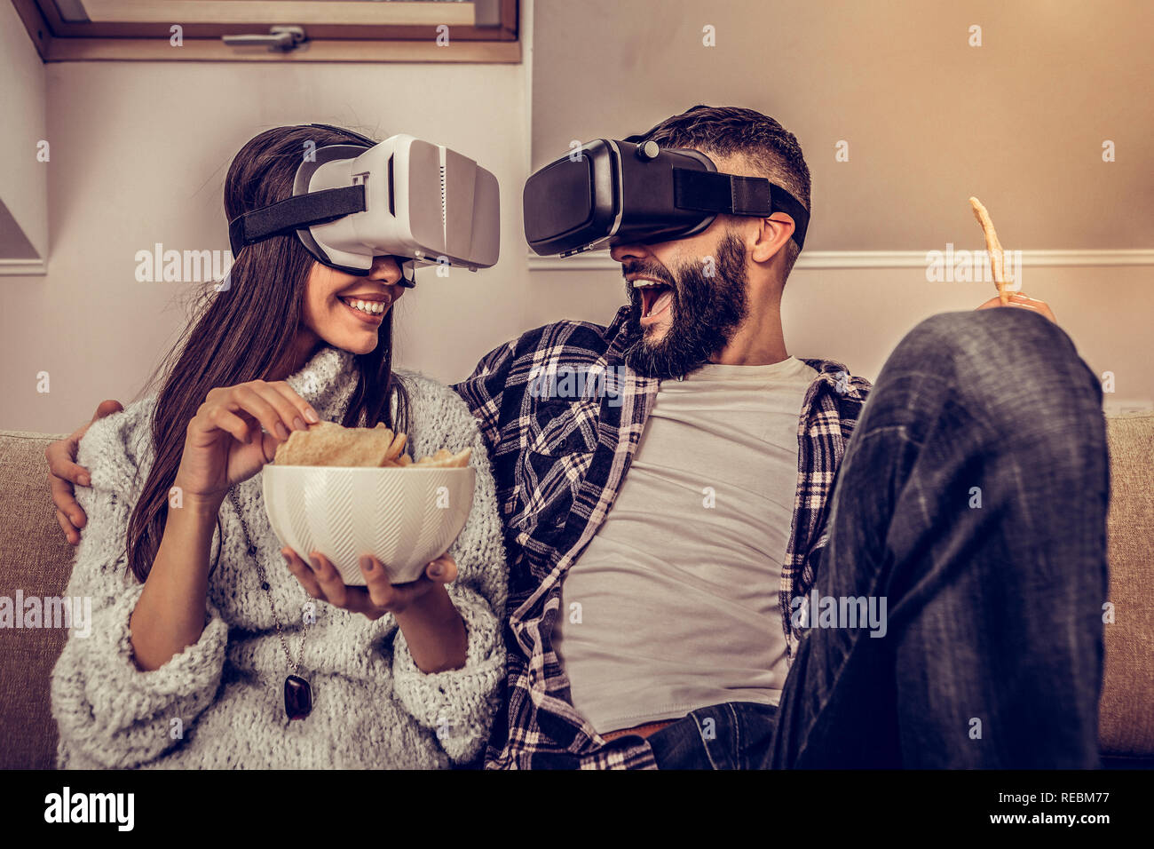 Delighted positive couple using latest digital technologies Stock Photo