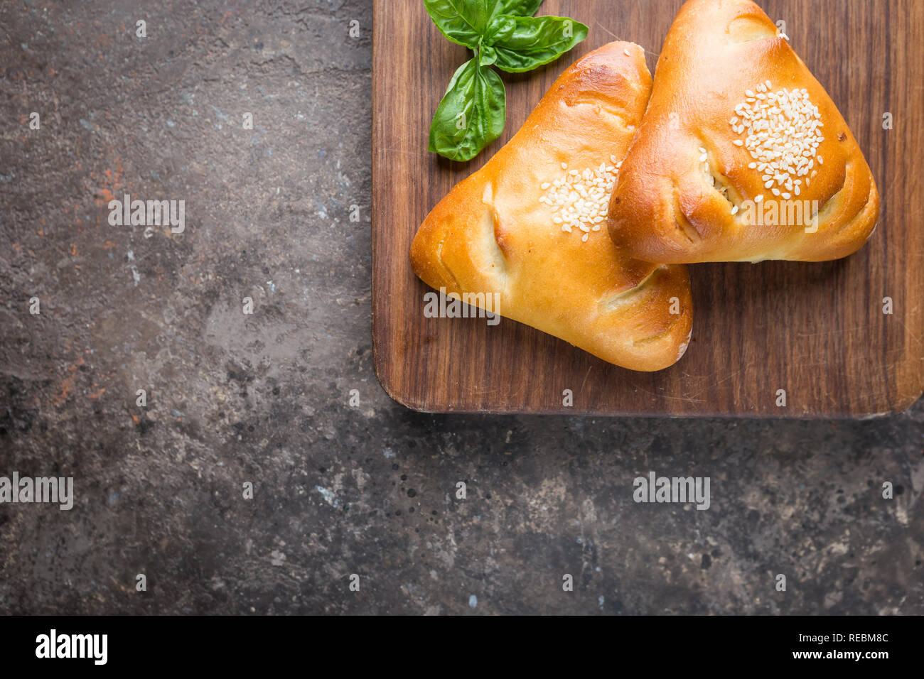 Homemade chicken and mushroom mini pies on cutting board, top view Stock Photo